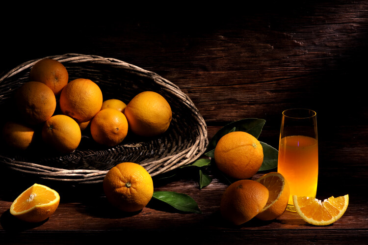 Plakát Oranges out of a basket and glass of juice