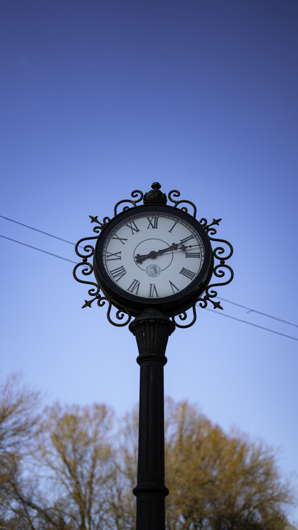 Плакат Time on a bright blue sky background