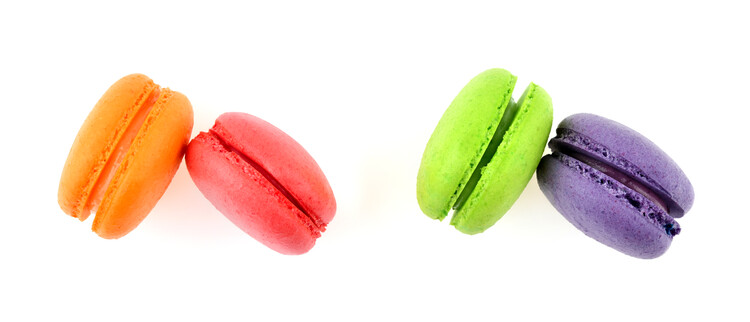 Poster Differents colored macaroons isolated on white. Top view