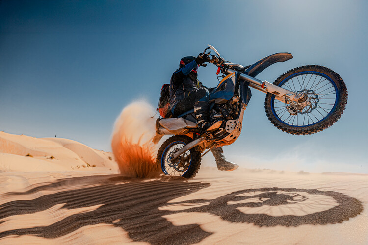Poster Motorbiker Rearing the Bike Through Sand Dunes, Wide Shot